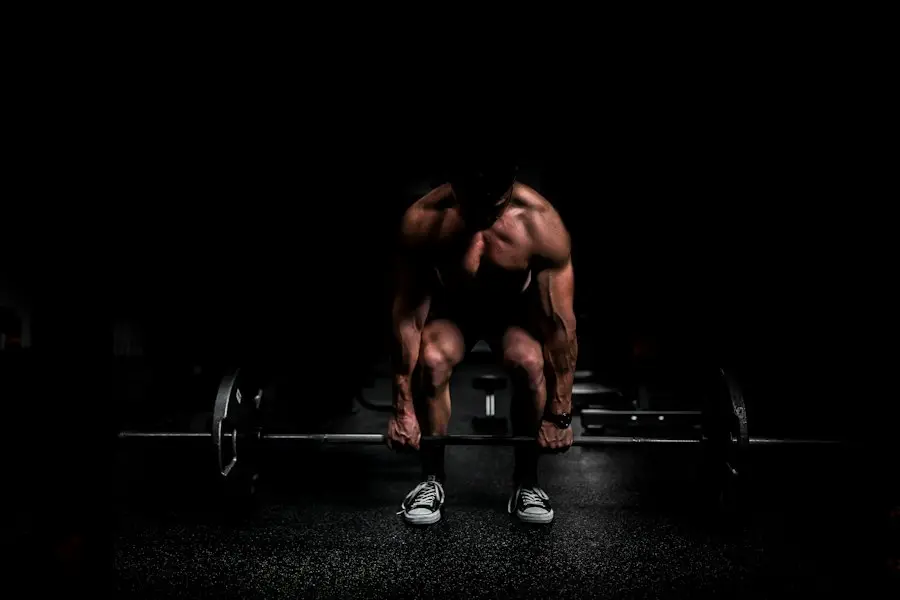 Deadlift silhouette in a dark gym