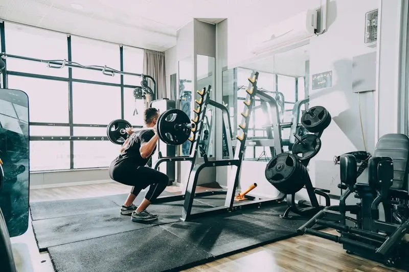Squat rack in a bright commercial gym