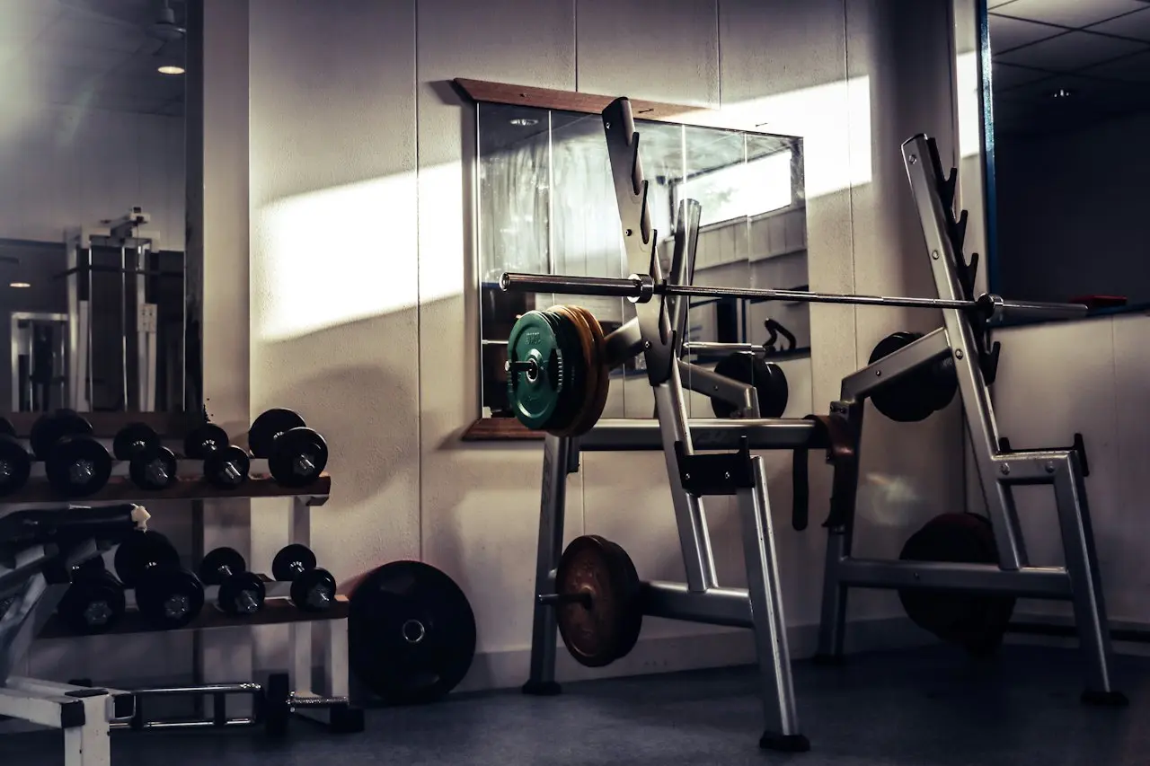 Power rack, bench, barbell and dumbbells on a commercial floor